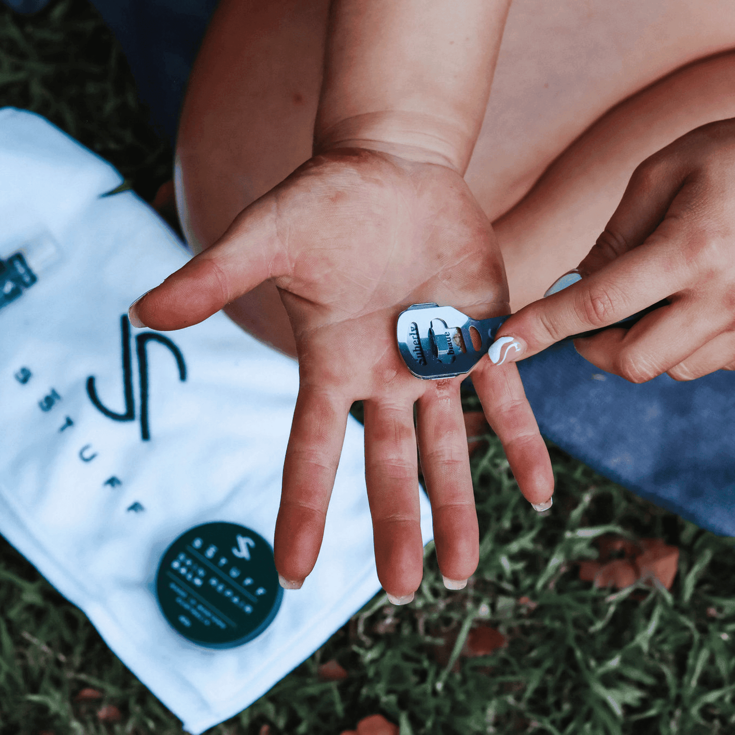 Athlete removing calluses on hand using a callus shaver